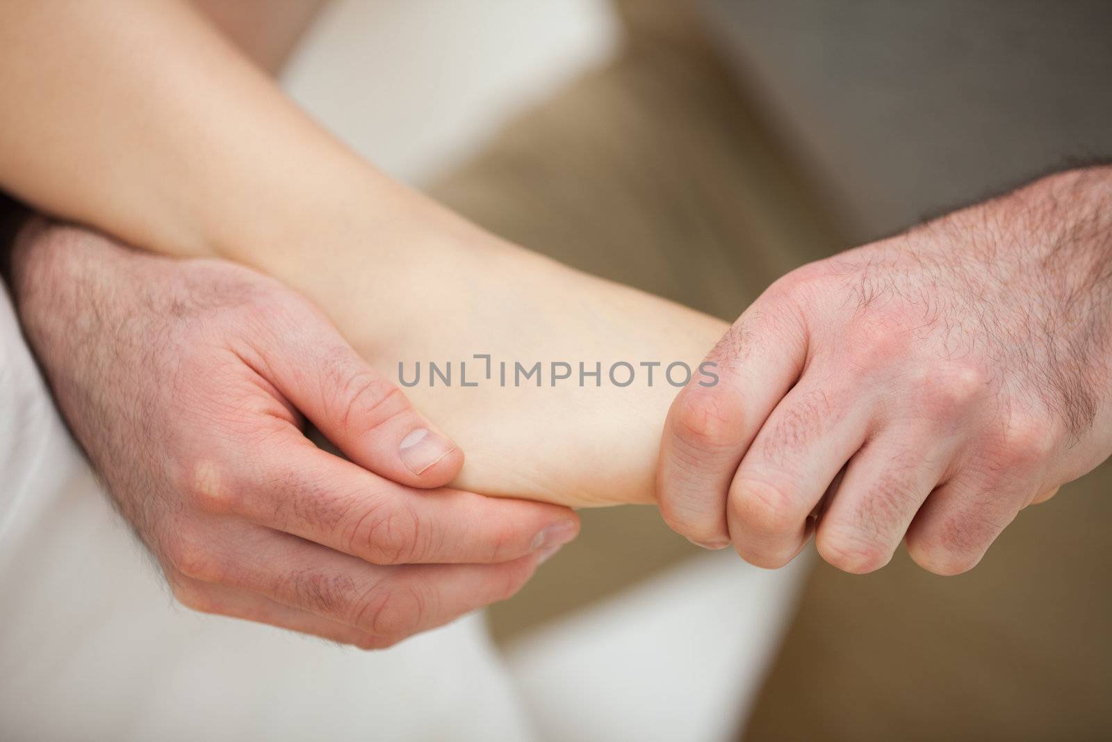 Foot being stretched by a physiotherapist in a room
