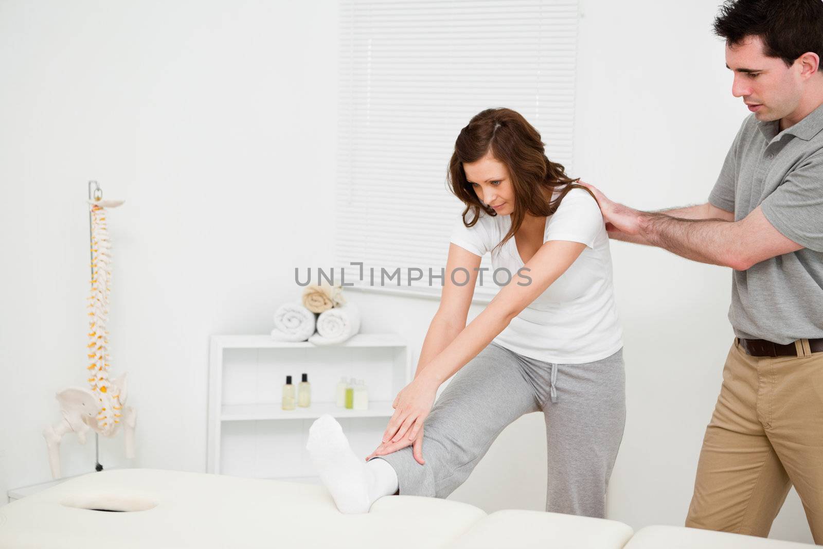 Peaceful woman stretching her body in a medical room
