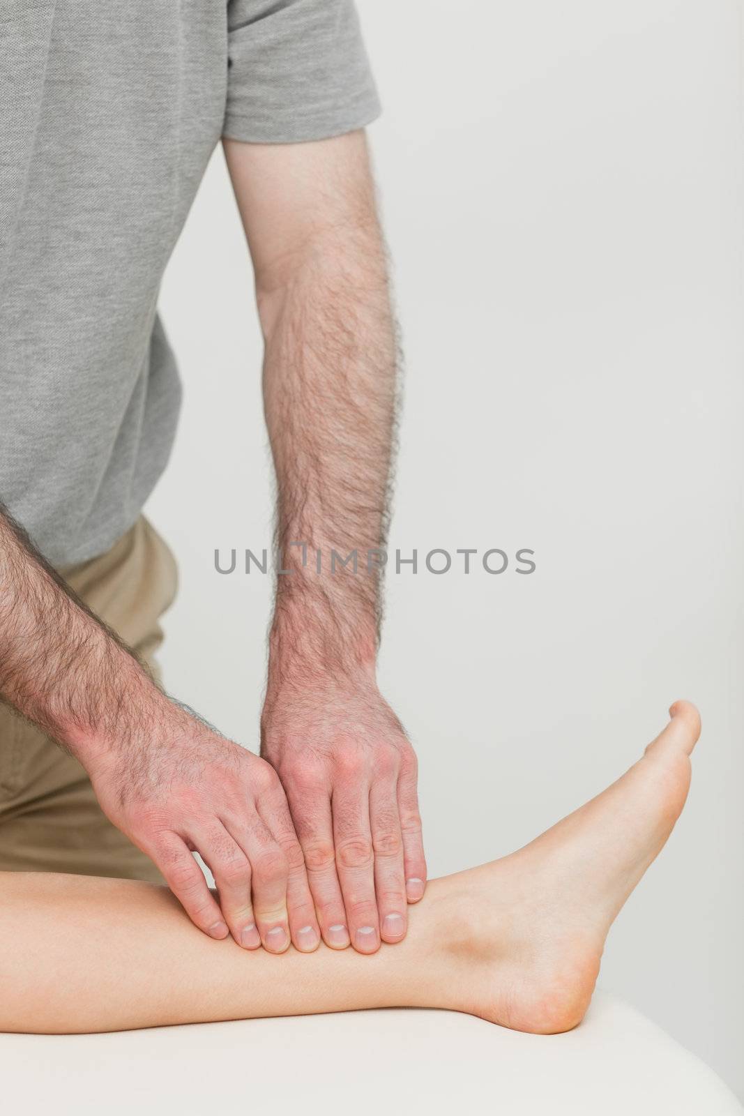 Fingertips massaging a shin bone by Wavebreakmedia