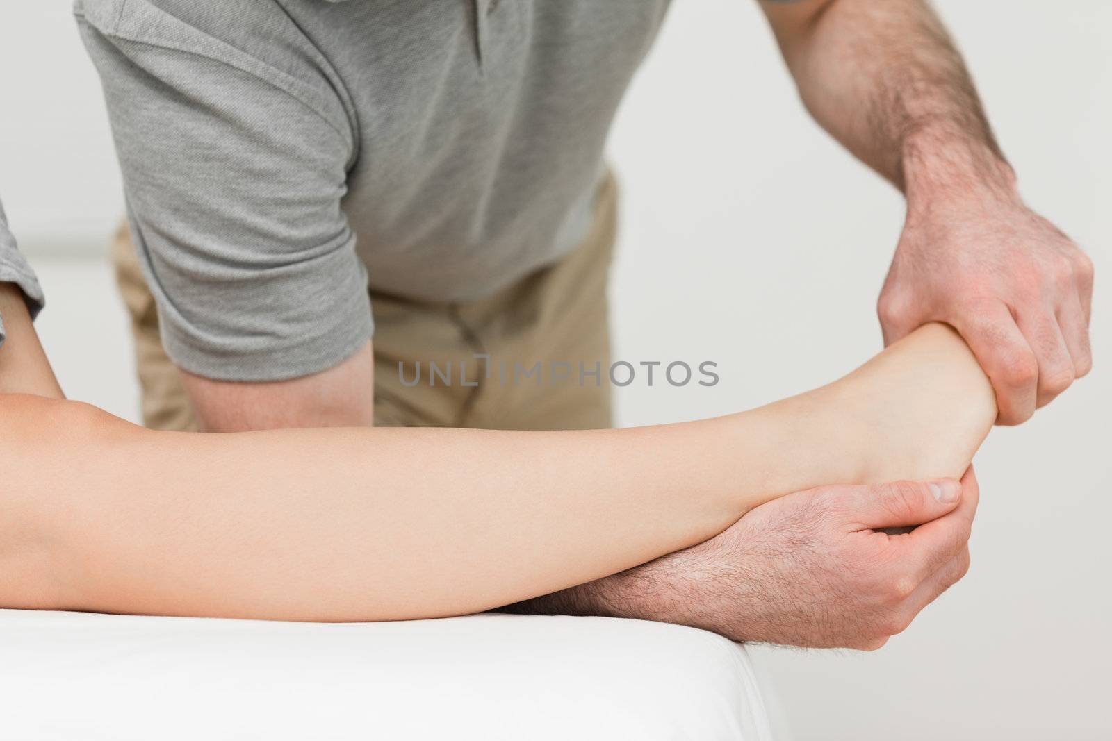 Physiotherapist stretching the ankle of a patient in a room