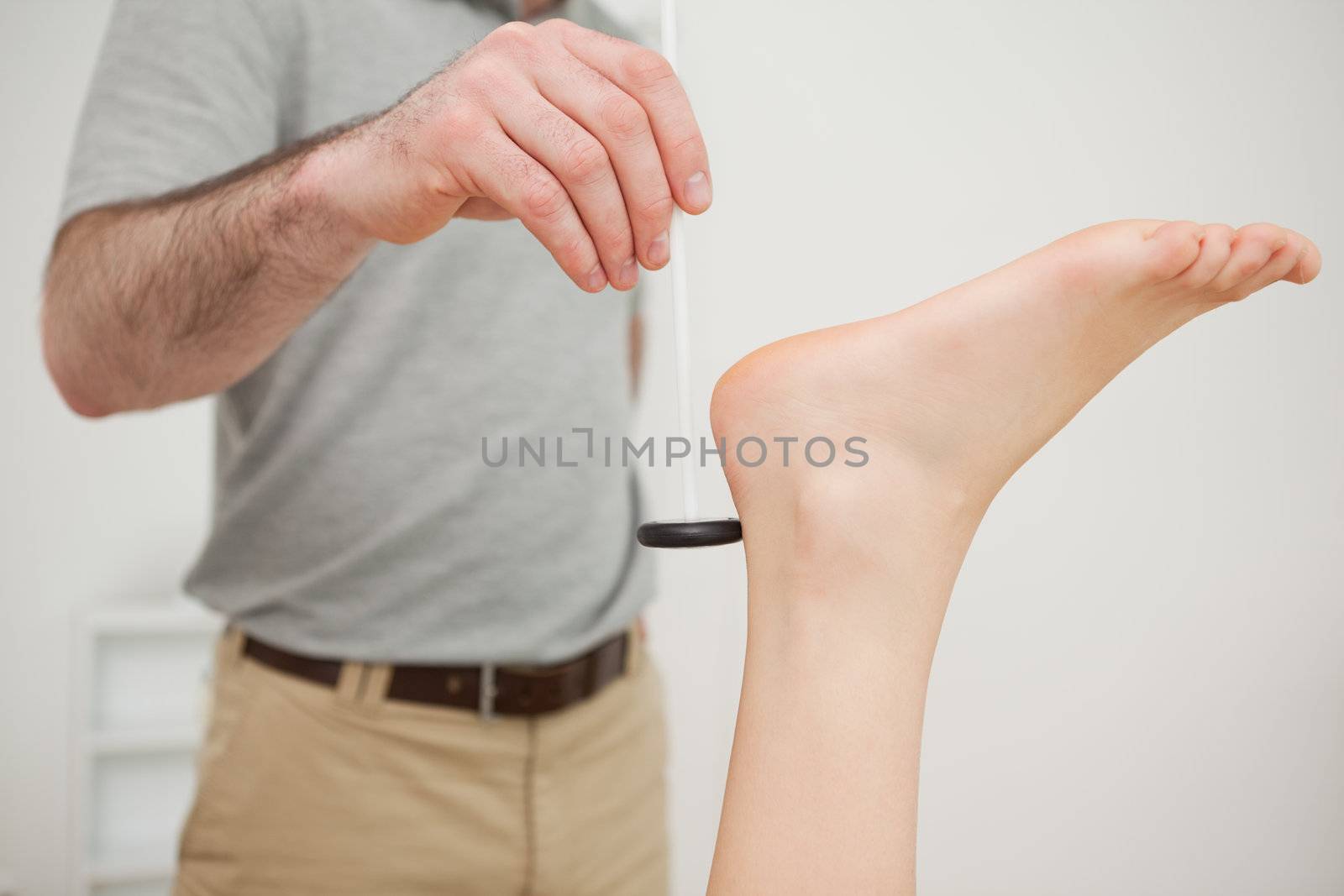 Reflex hammer being held by a doctor in a medical room