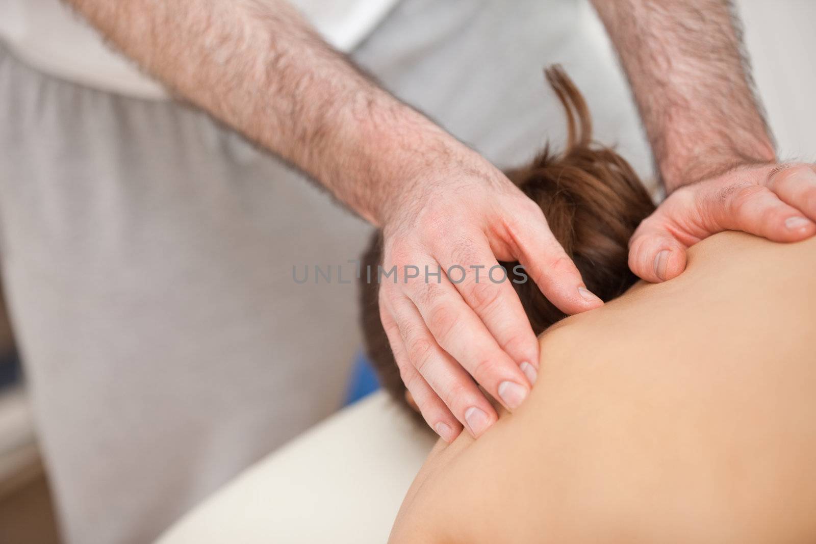 Chiropractor touching the back of his patient by Wavebreakmedia