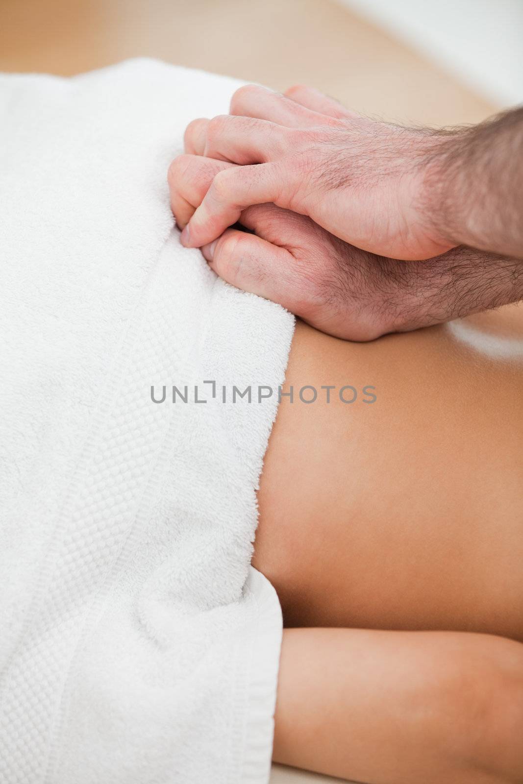 Close-up of doctor massaging the back of his patient in a room