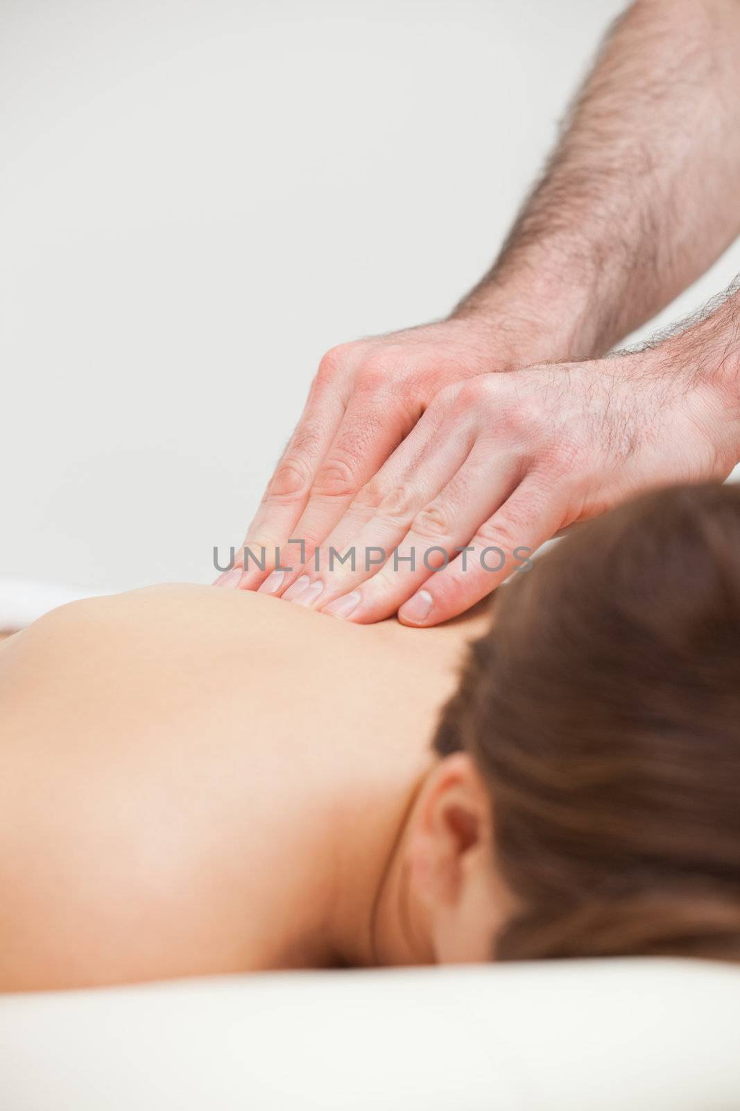 Close-up of woman being massaged by a doctor in a room