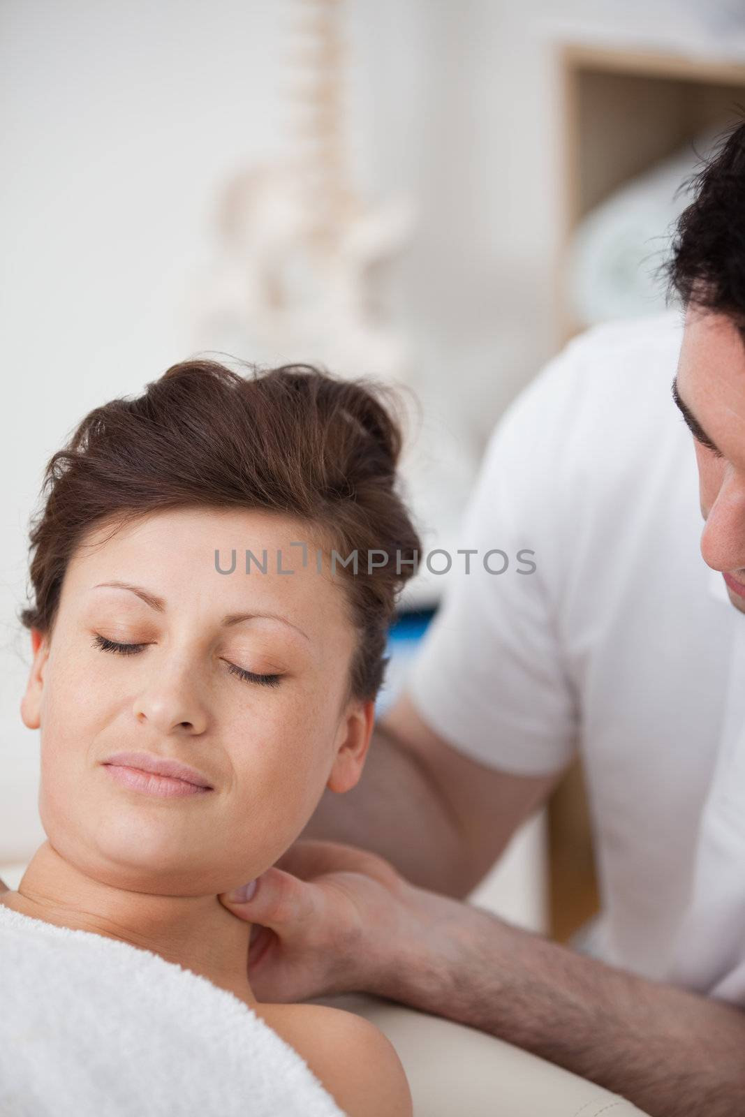 Woman being massaging her head while raising it by Wavebreakmedia