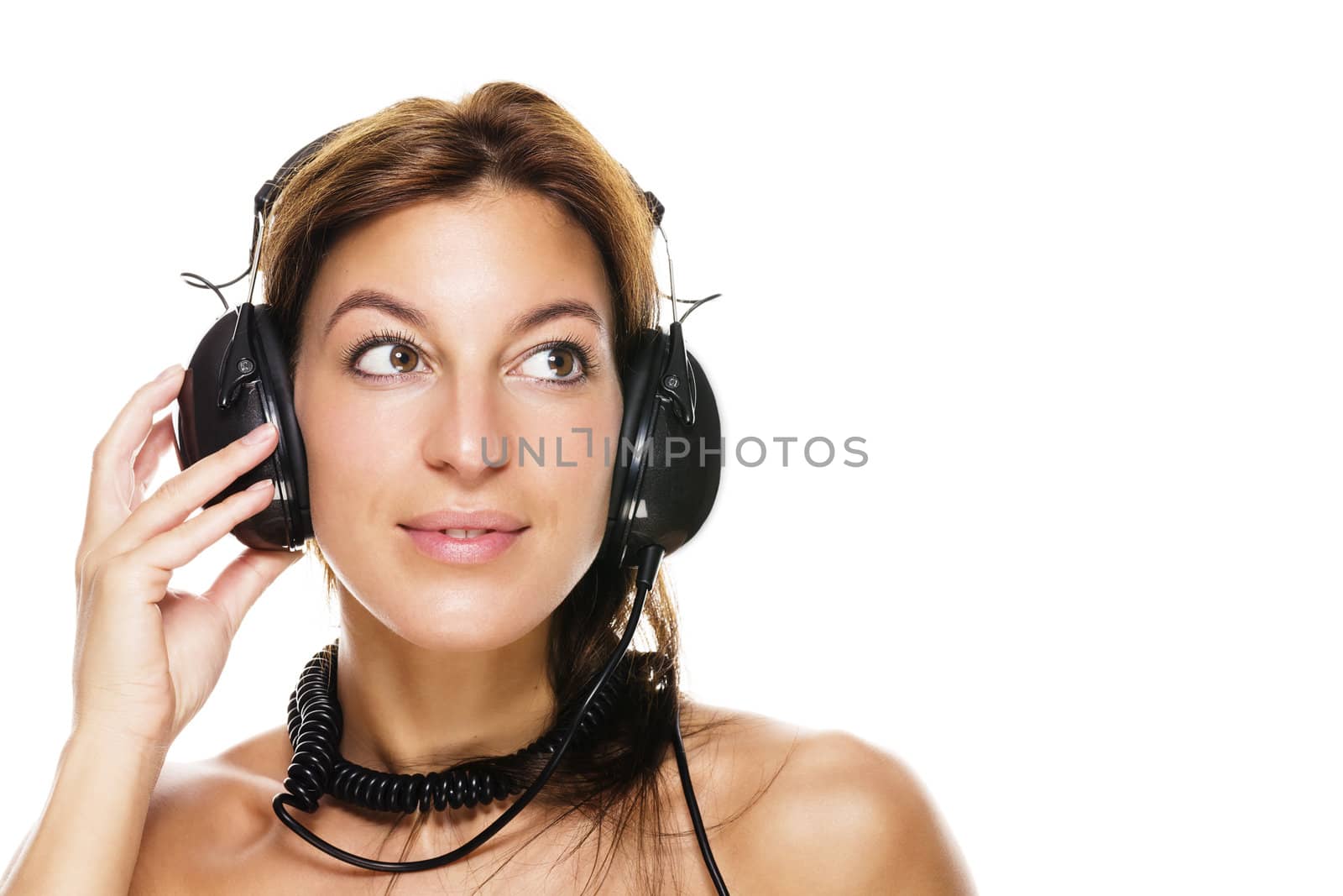 beautiful brunette woman listening to music on white background