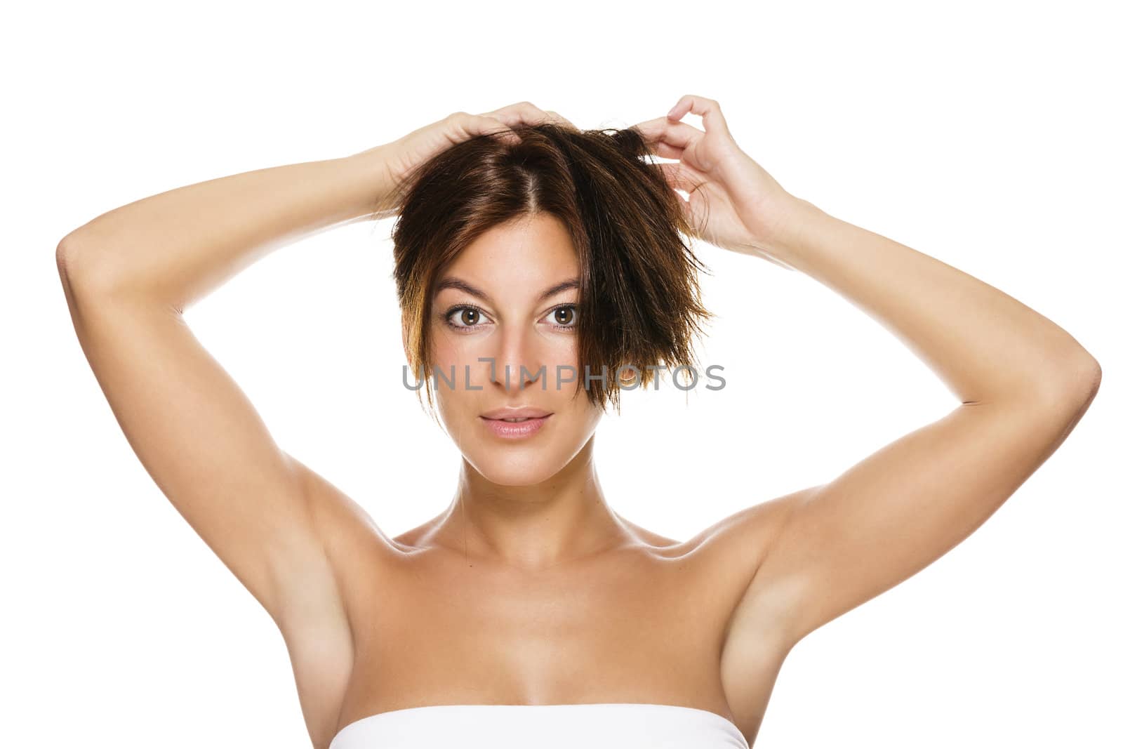 beautiful brunette woman holding her hair on white background