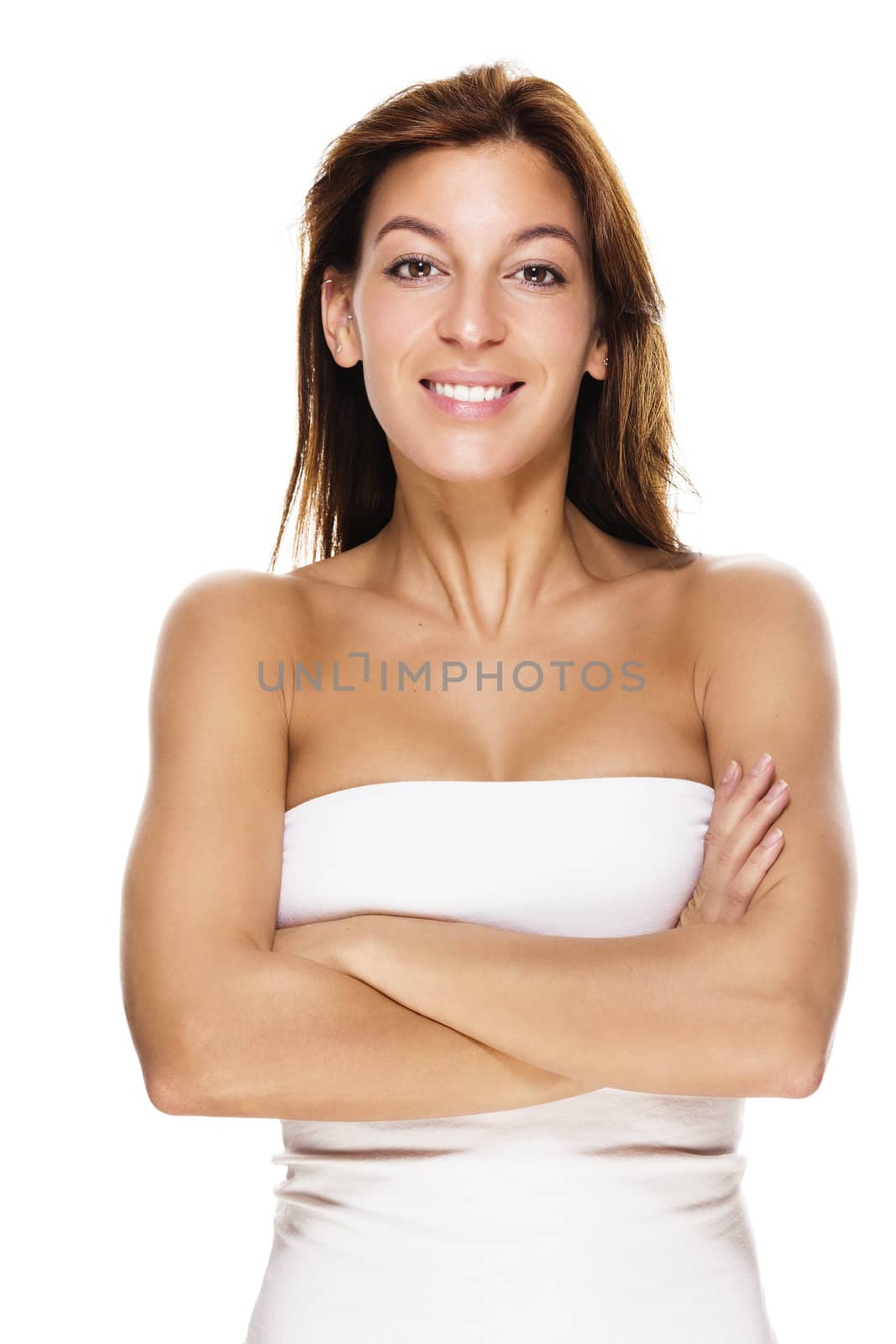 laughing brunette woman with crossed arms on white background