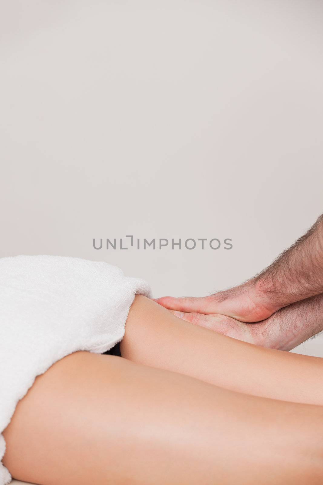 Woman being massaged her thigh by a masseur by Wavebreakmedia