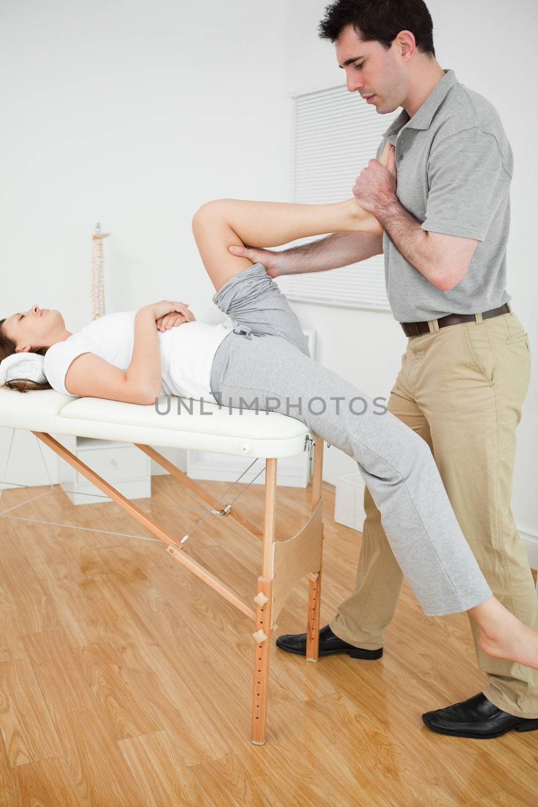 Woman putting her foot on the chest of her doctor  by Wavebreakmedia