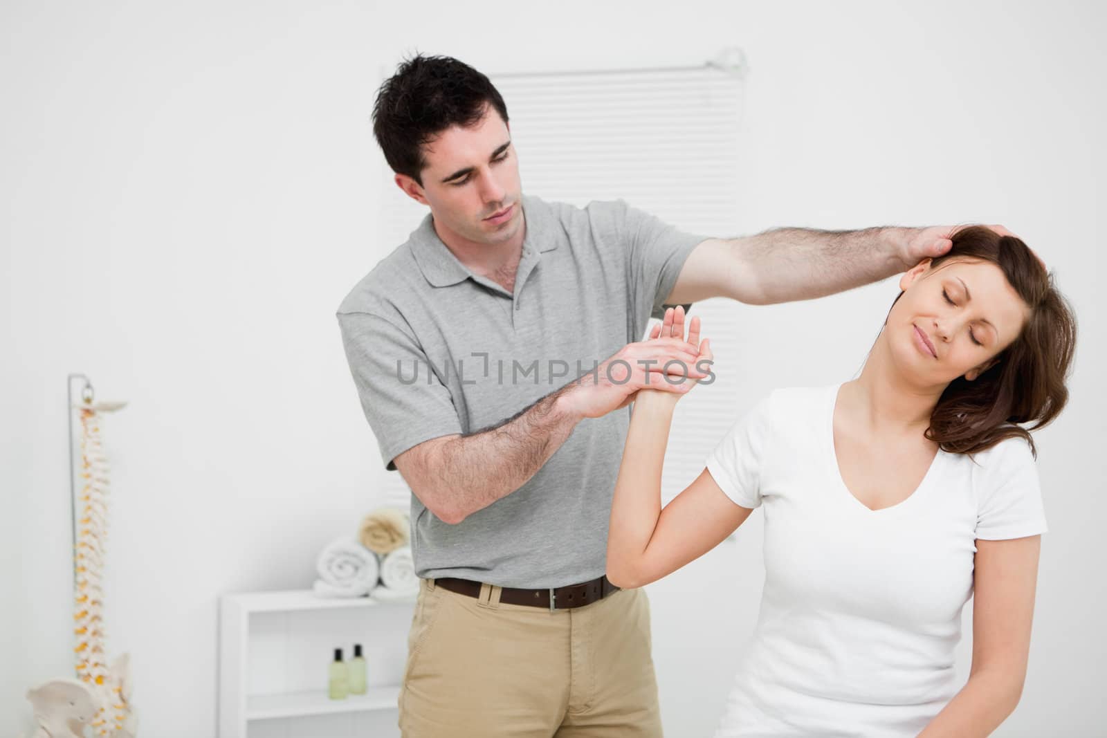 Woman being examined her neck by a doctor  in a medical room