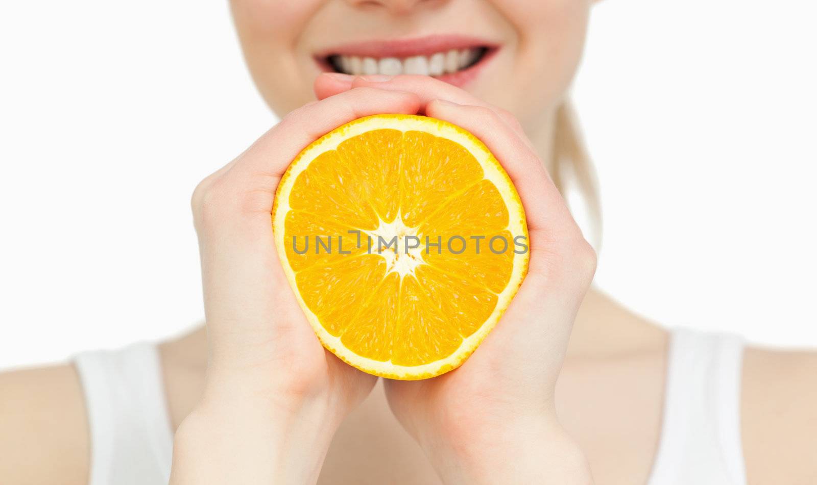 Close up of a woman holding an orange by Wavebreakmedia