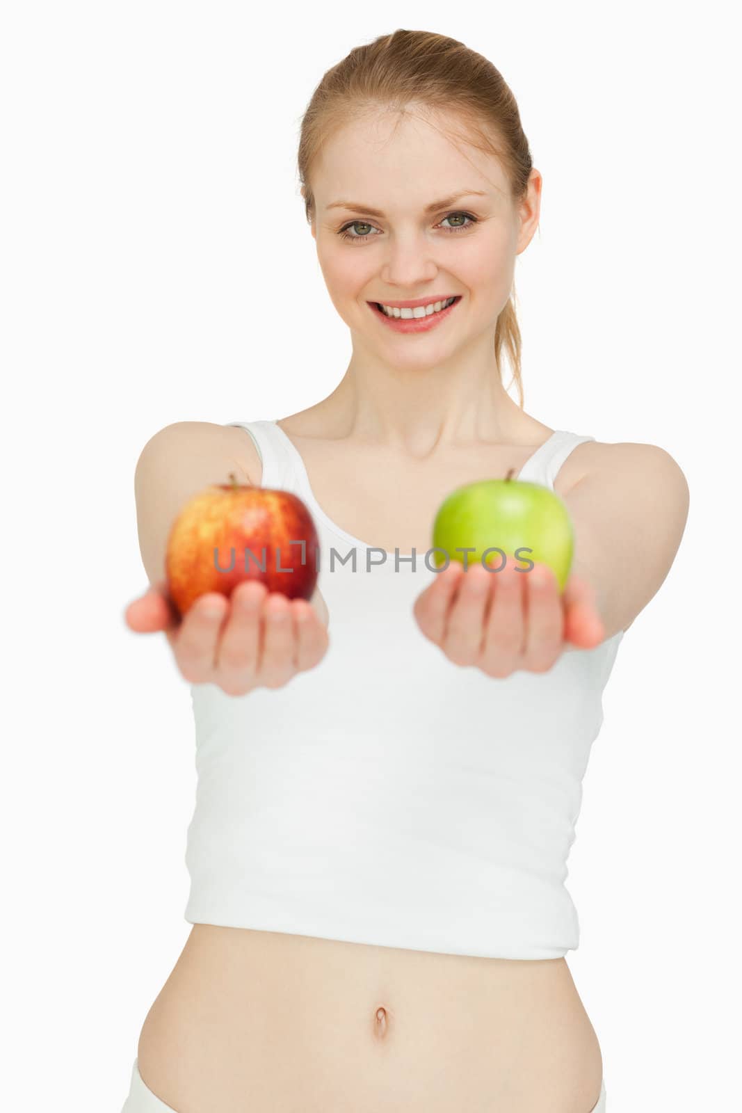Joyful woman presenting two apples against white background