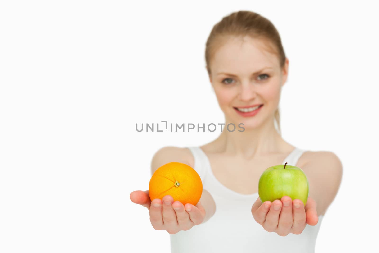 Young smiling woman presenting fruits against white background