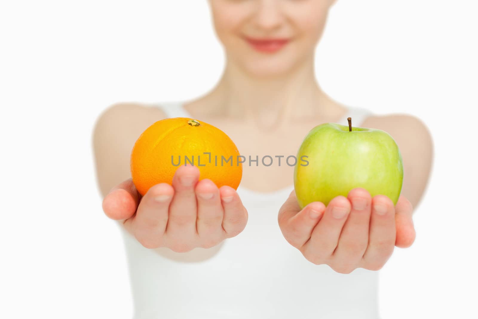 Close up of a woman presenting fruits against white background