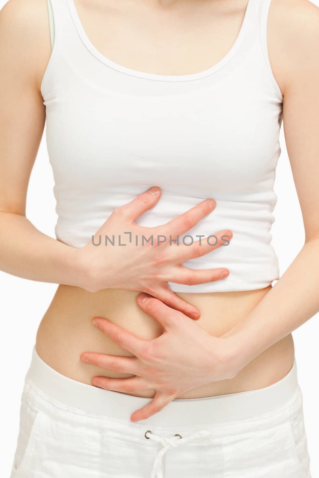 Woman touching her belly against white background