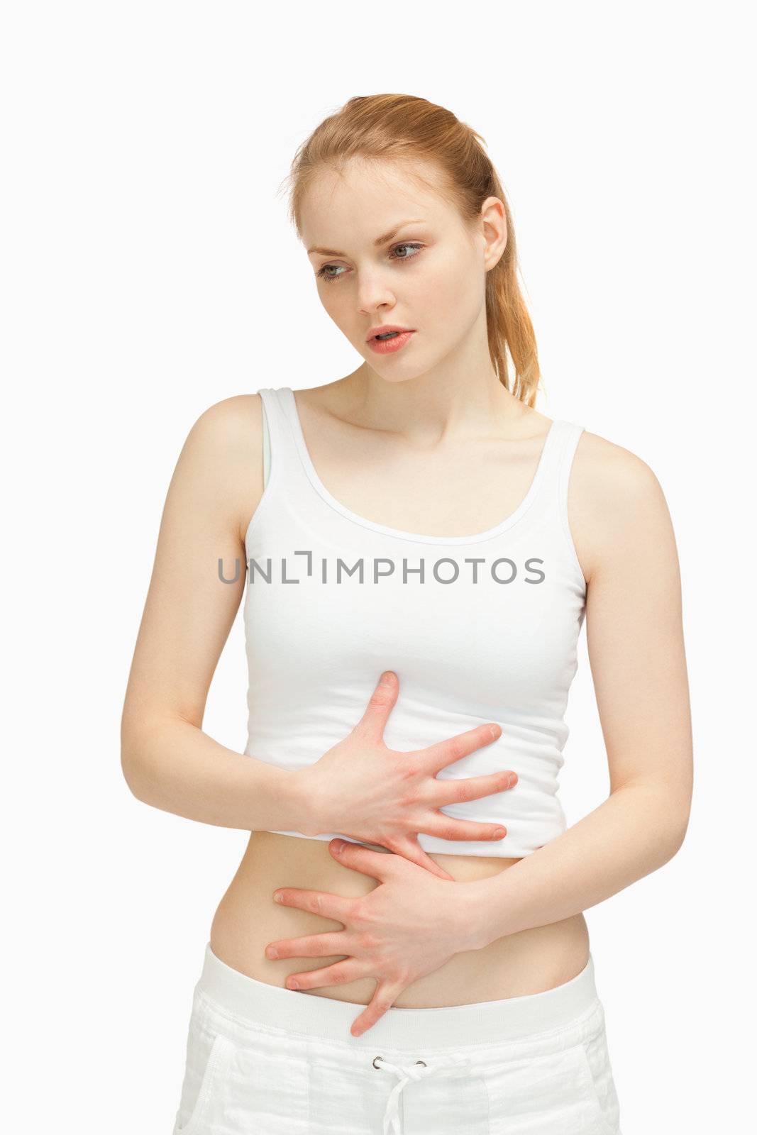 Serious woman placing her hands on her stomach