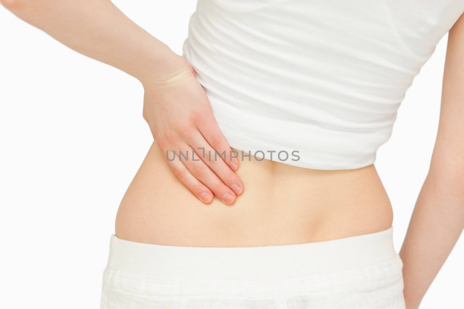 Close up of a woman massaging her back against white background