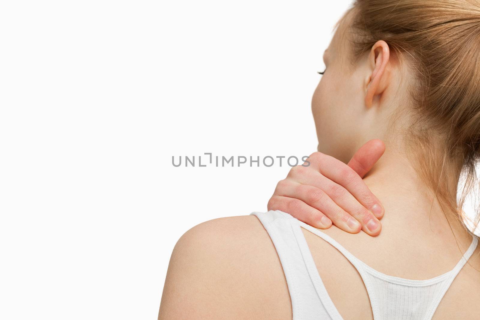 Woman massaging her painful neck against white background