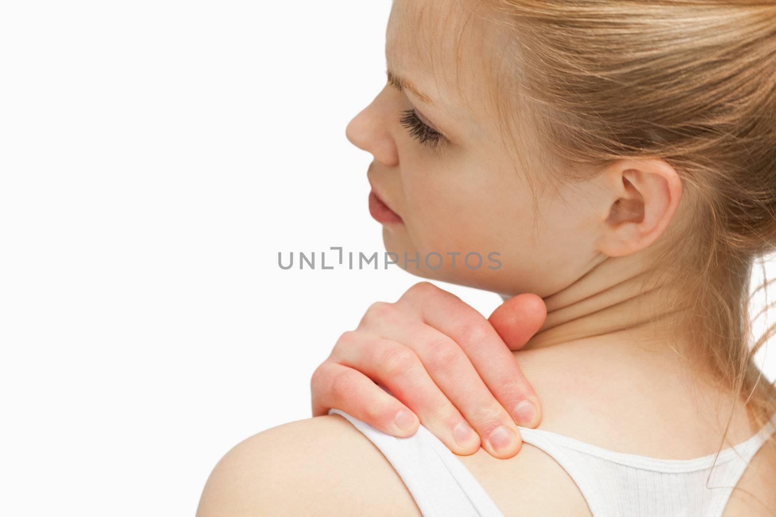 Close up of a woman massaging her nap against white background