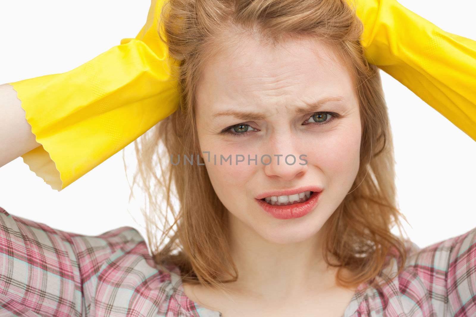 Close up of a woman pulling her hair against white background
