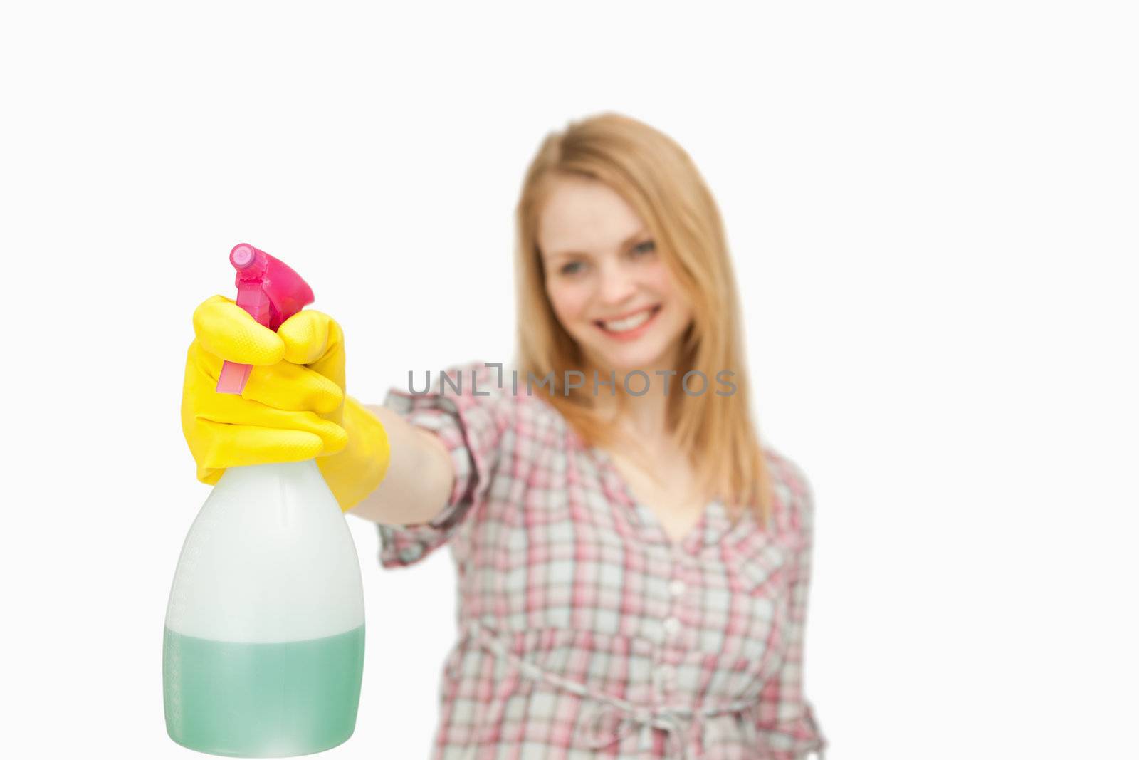 Woman holding a spray bottle against white background