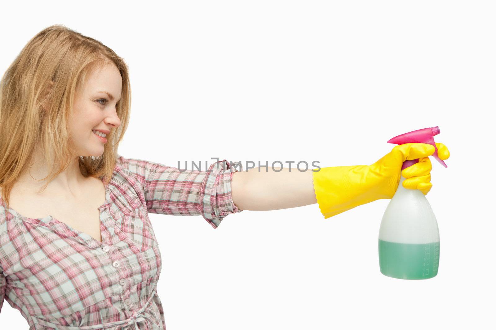 Blond-haired woman holding a spray bottle against white background