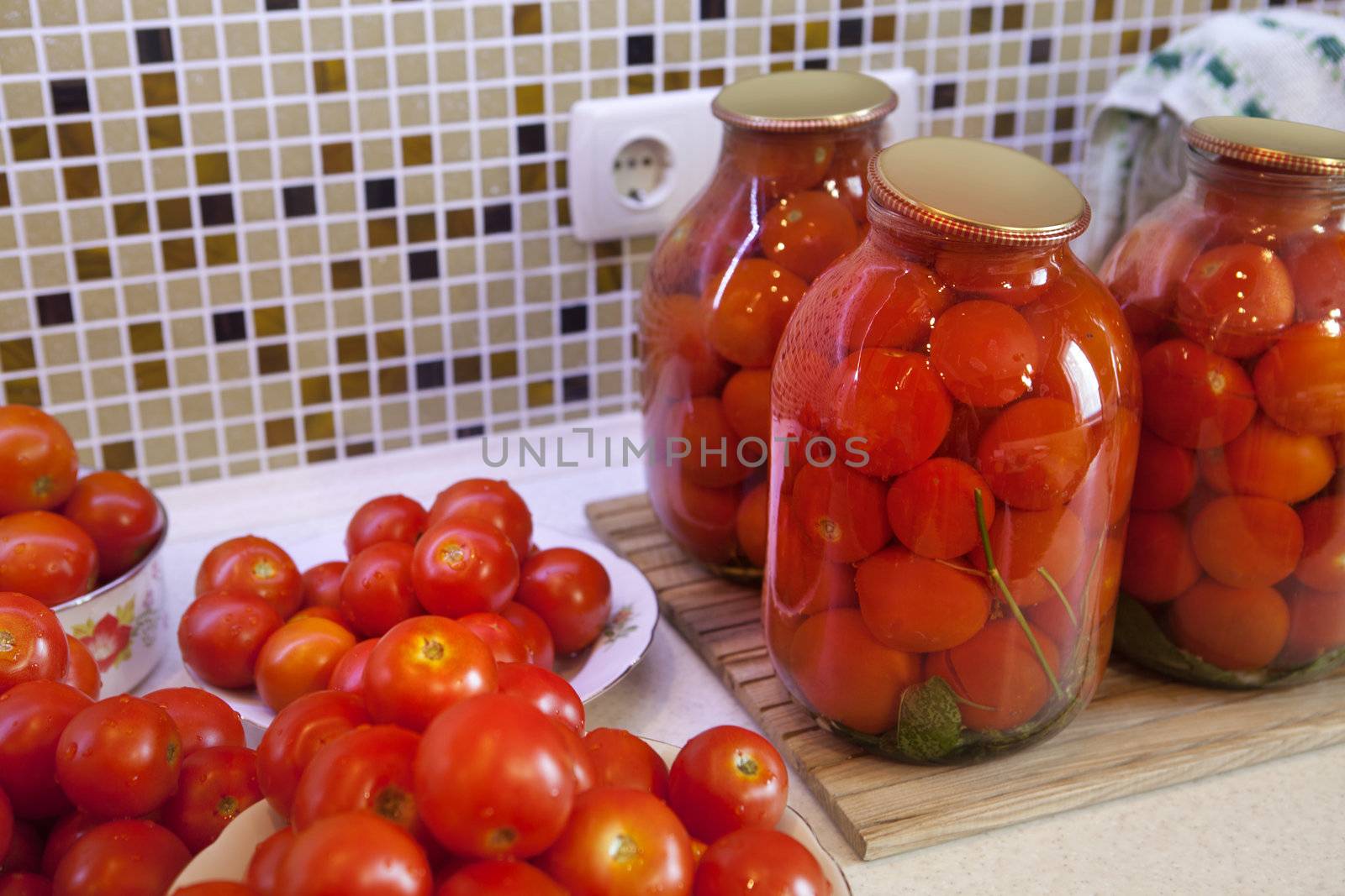 pickles tomatoes on plate prepared for pasteurization