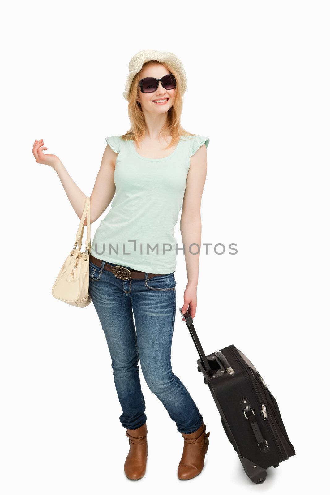 Woman standing while holding baggages against white background