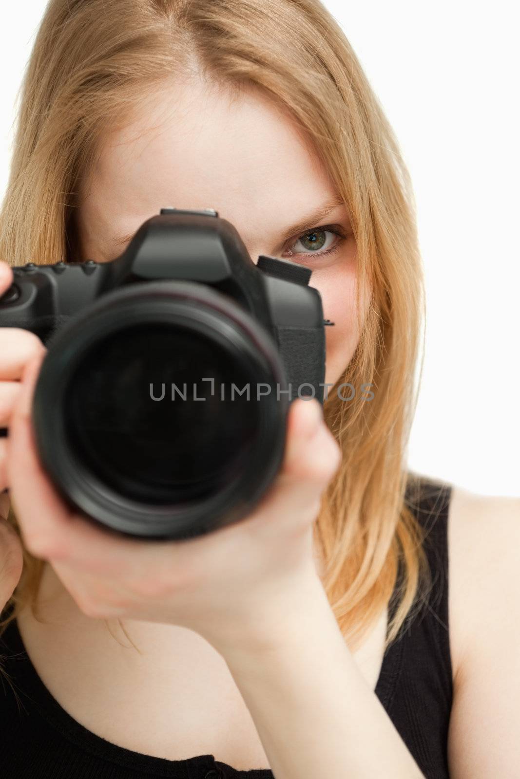 Close up of a woman holding a camera against white background