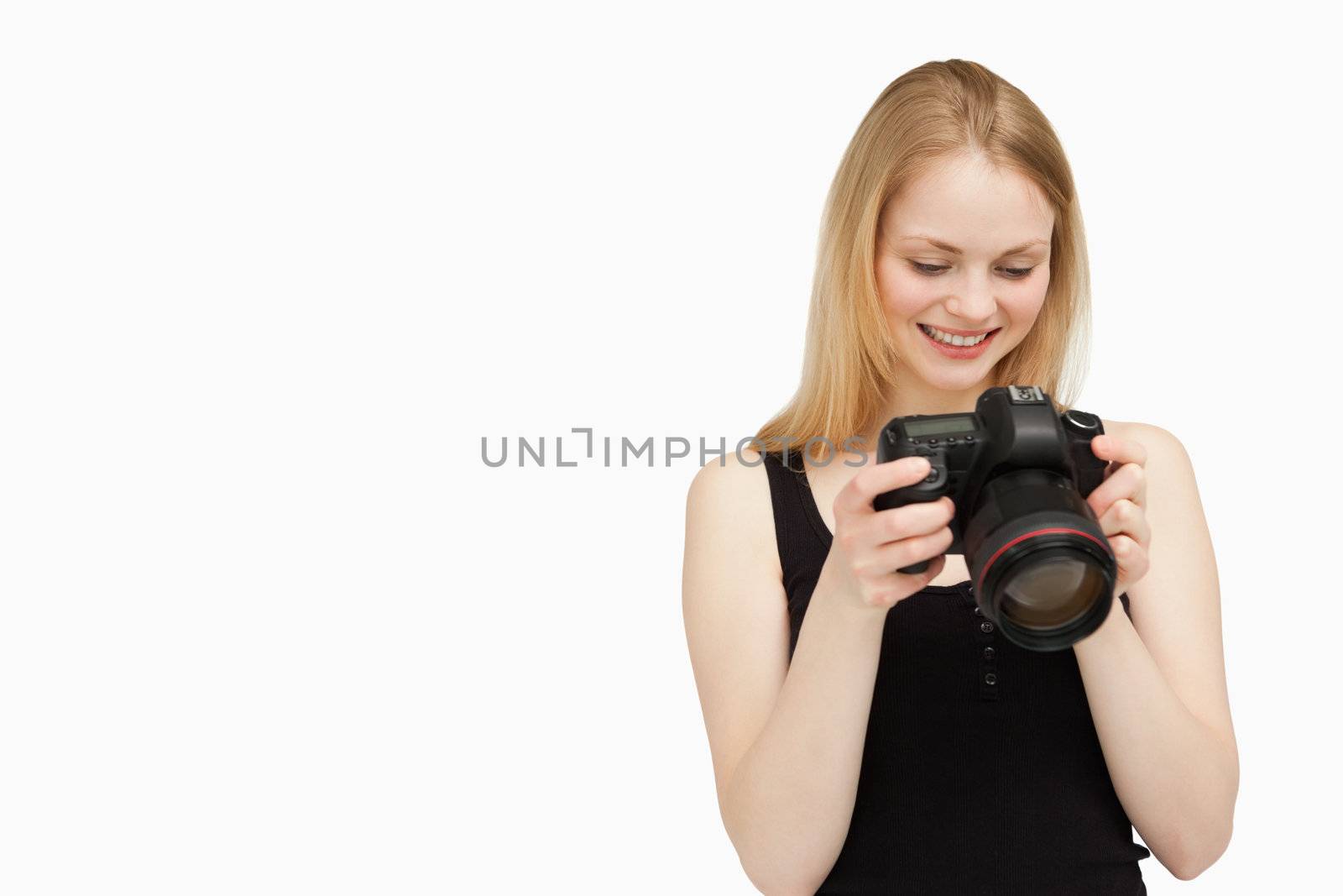 Cheerful woman looking at her camera against white background