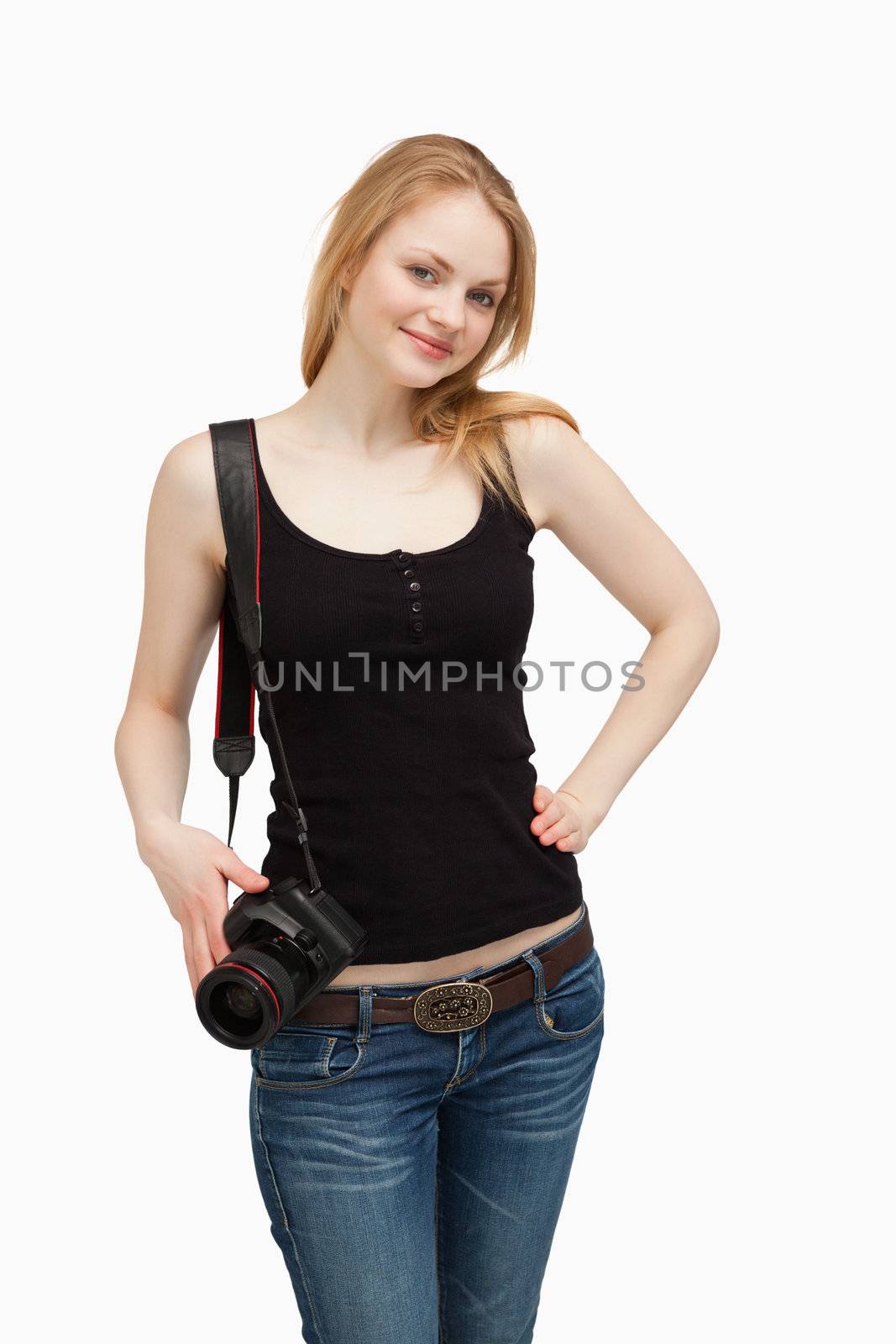 Woman carrying a camera around her shoulder against her shoulder