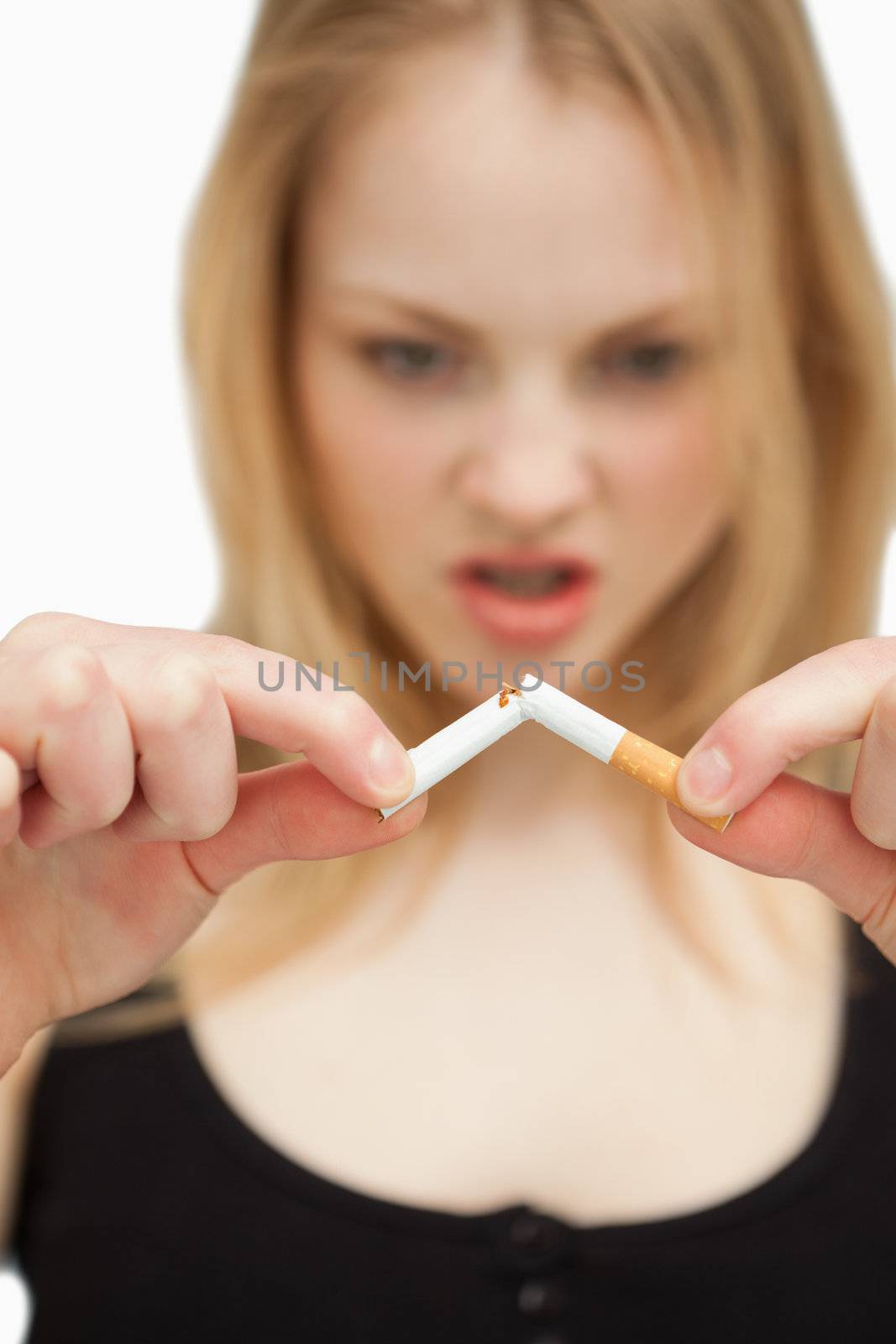 Woman braking a cigarette against white background