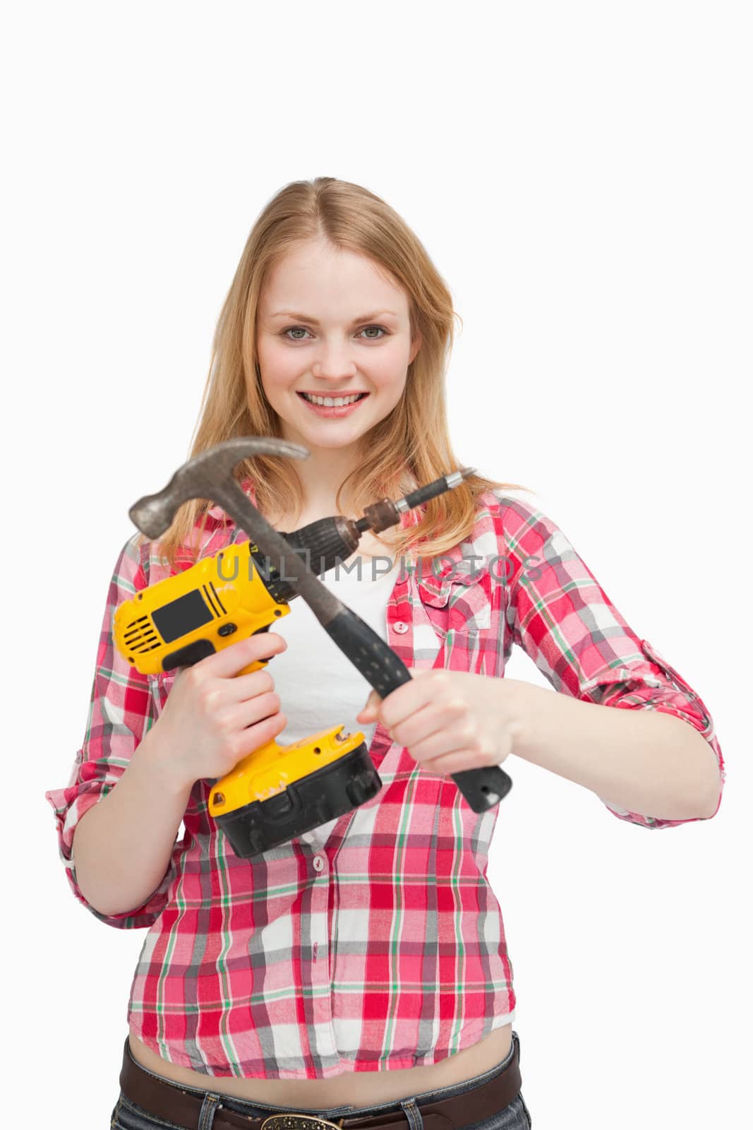 Young woman holding tools against white background