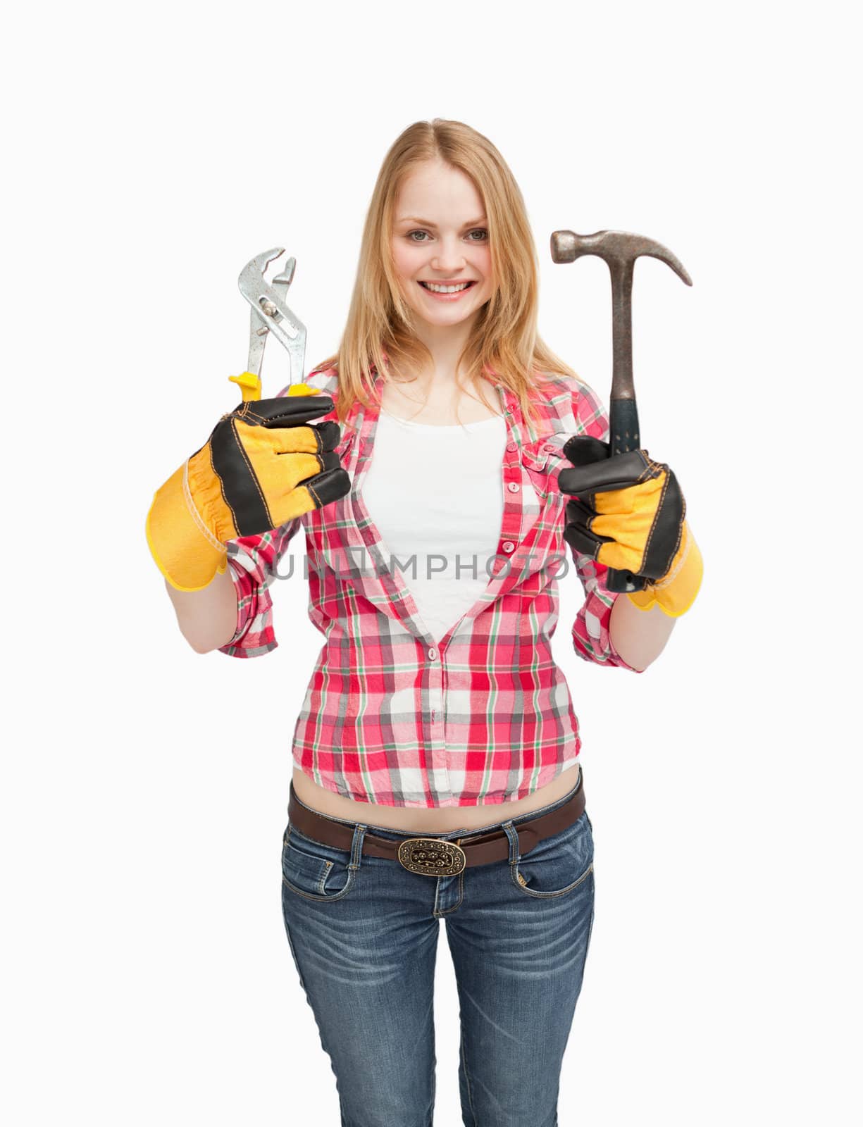 Cheerful woman holding tools against white background