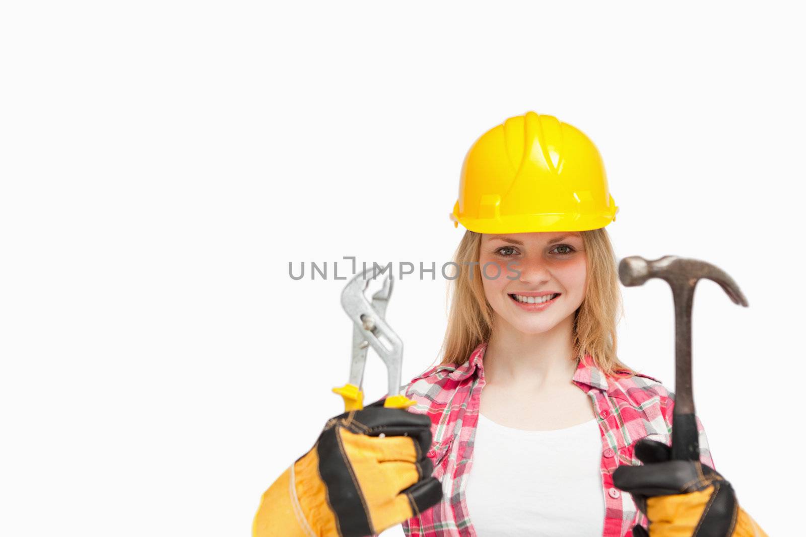 Woman smiling while wearing a safety helmet against white background
