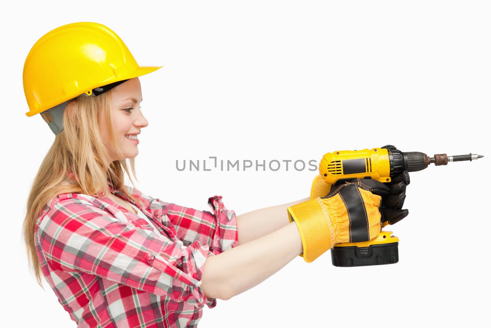 Woman using an electric screwdriver against white background