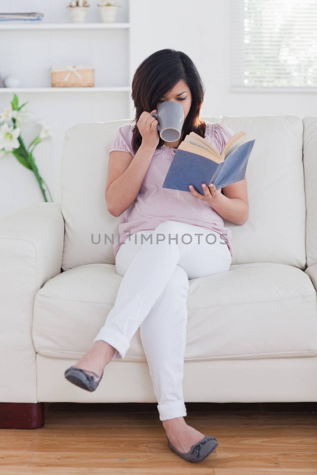 Woman holding a mug in a living room