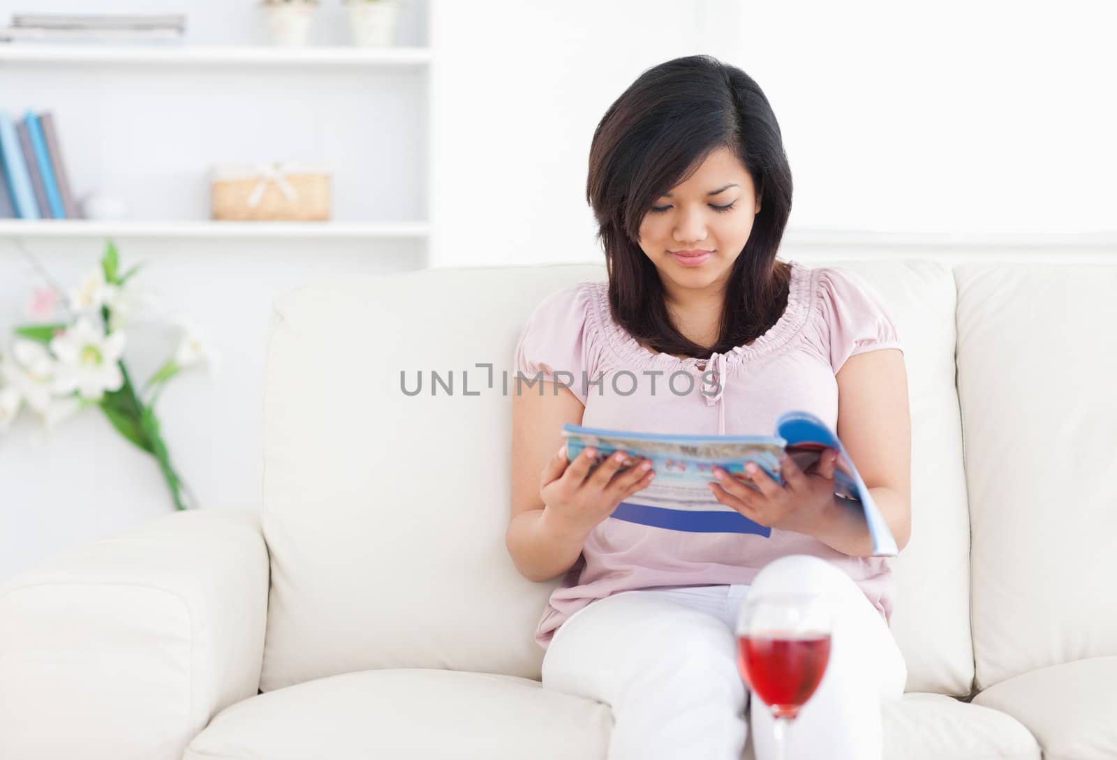 Woman reading a magazine in a living room