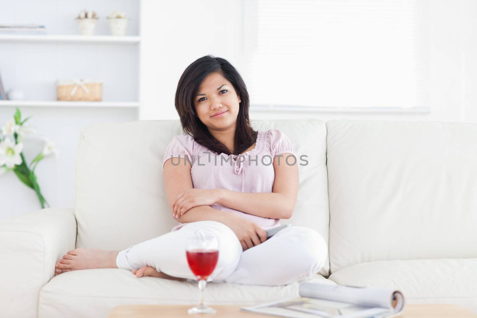 Woman smiling while sitting on a couch in a living room