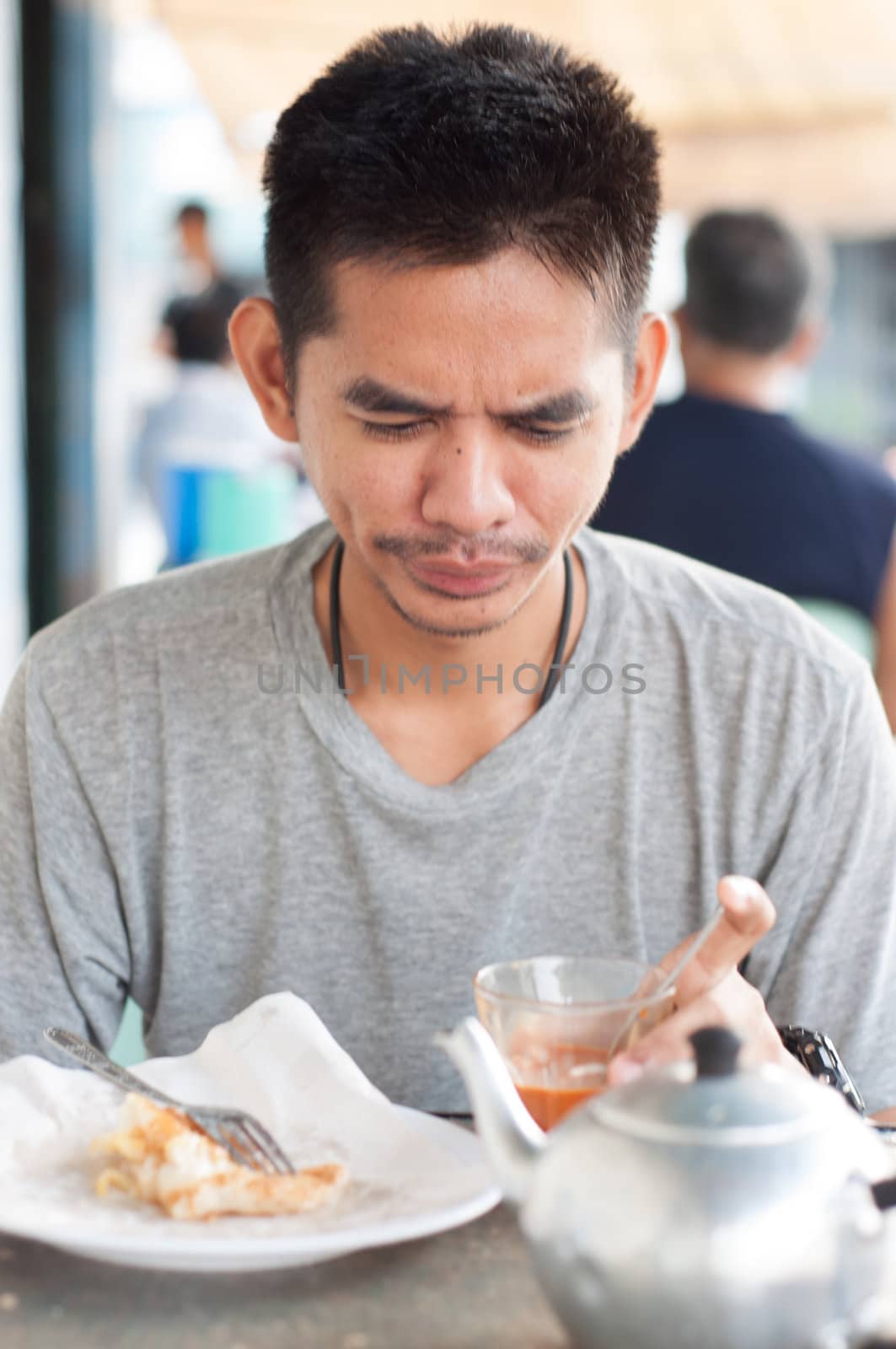 asian man enjoy eating breakfast by ngarare