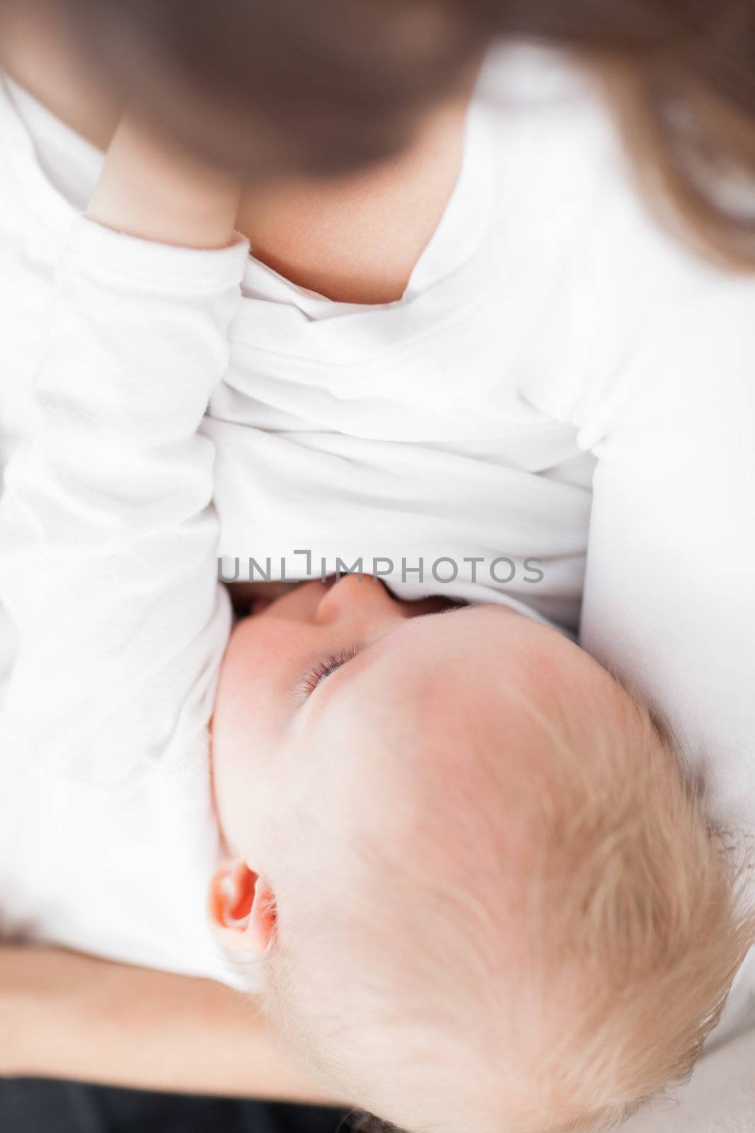 Cute baby being breastfed by Wavebreakmedia