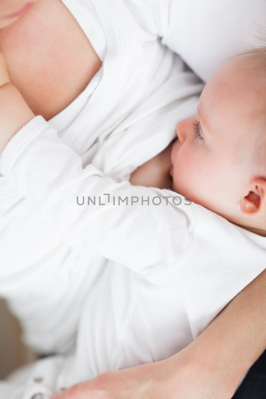 Close-up of a mother breastfeeding her cute baby