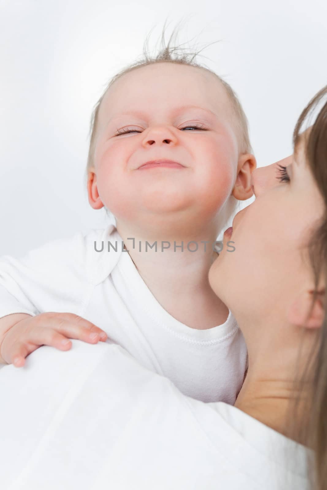 Cute baby being held by her mother by Wavebreakmedia