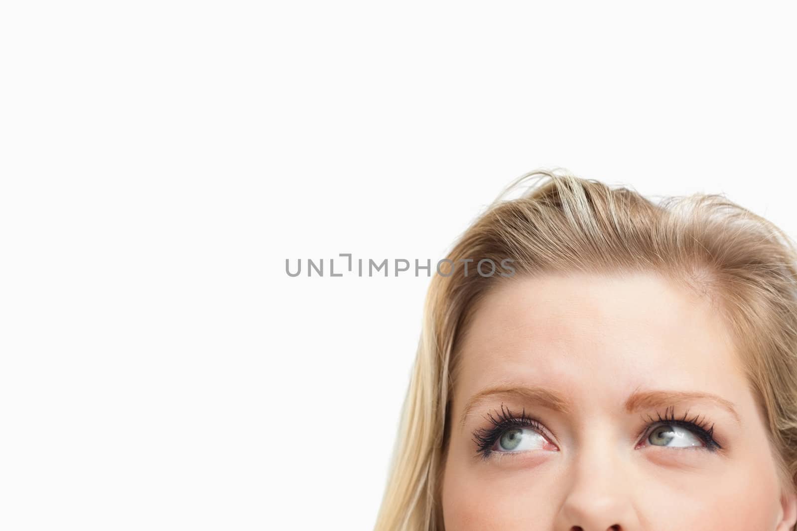 Blonde woman looking towards the side against a white background