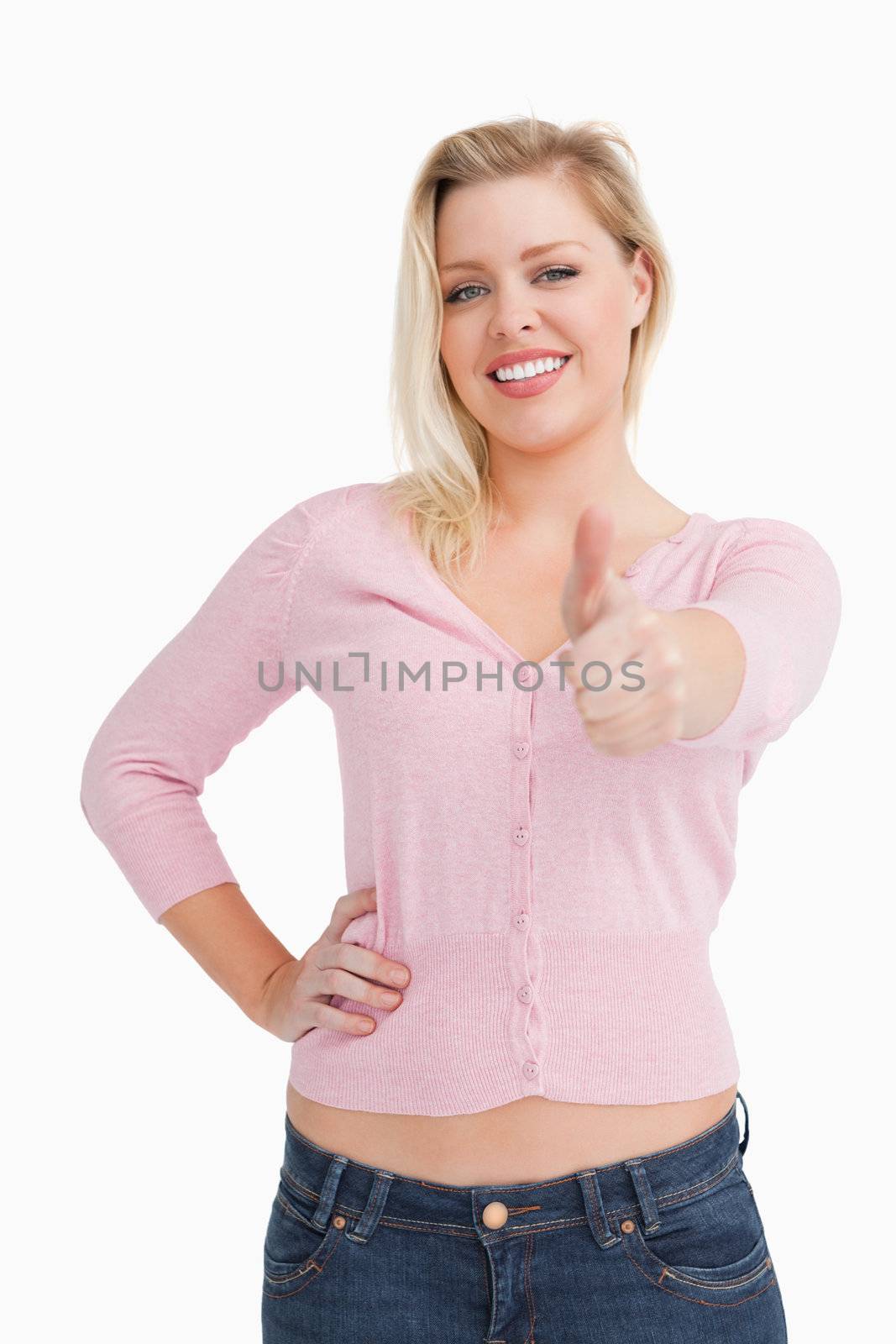 Woman standing upright while placing her thumbs up by Wavebreakmedia