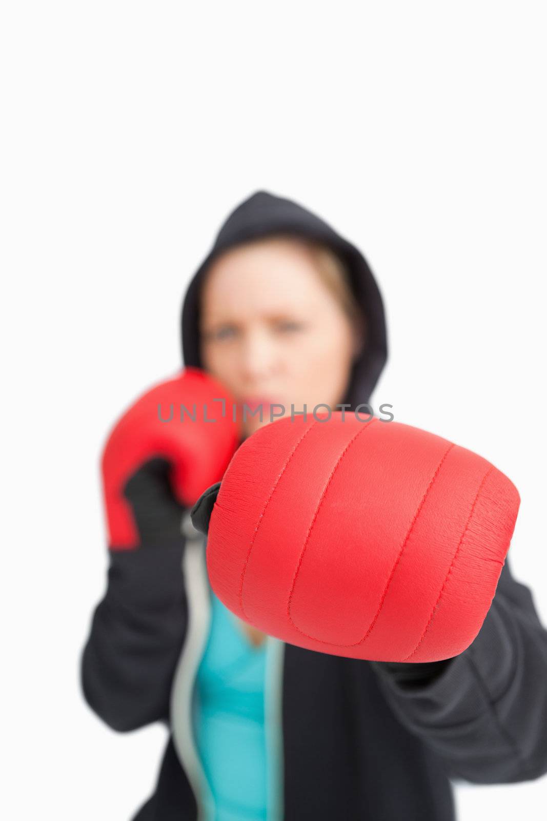 Woman boxing with a red gloves against white background