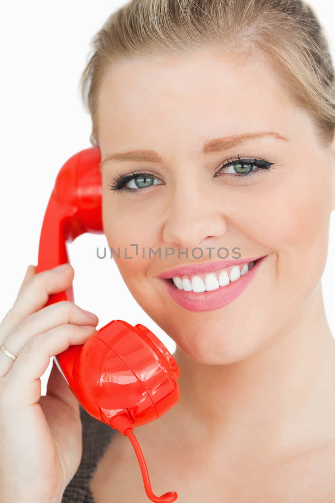 Woman smiling at a phone against white background