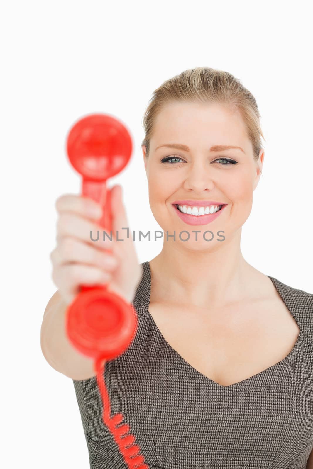 Pretty woman showing a retro phone against white background