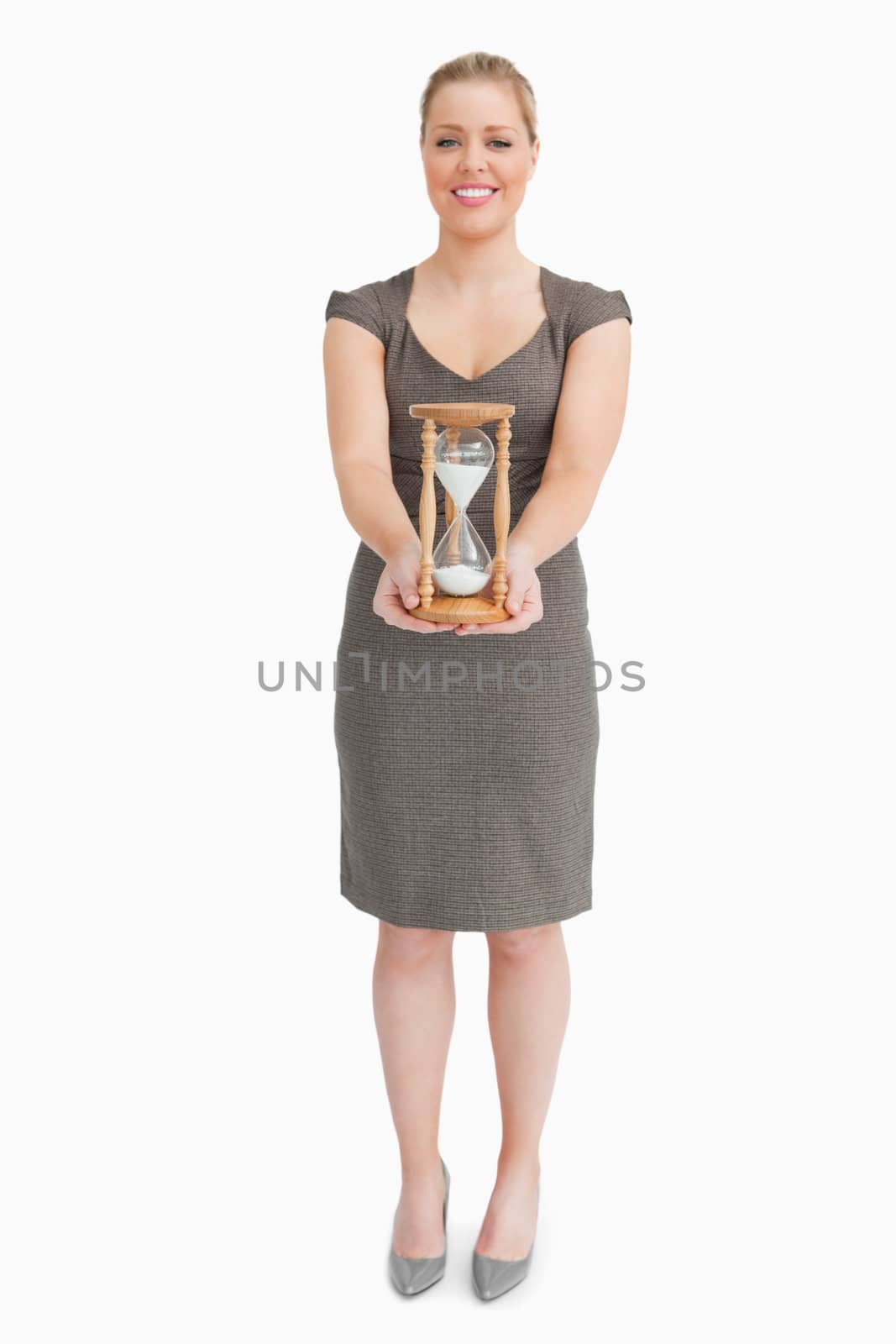 Woman holding a hourglass against white background